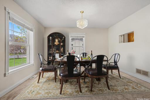 Elegant dining with easy access to kitchen and living spaces (virtually staged to show potential layout)