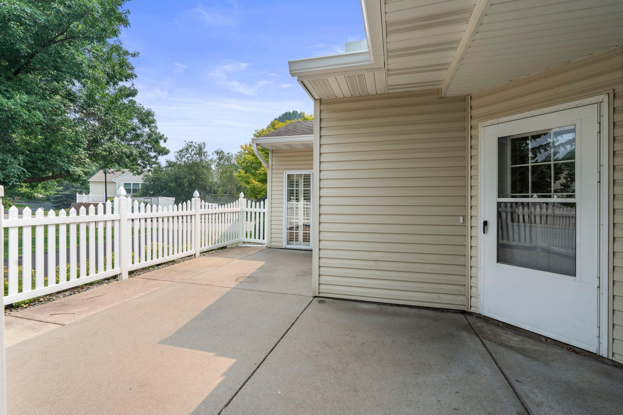 Fabulous patio with white picket fence to create some privacy.