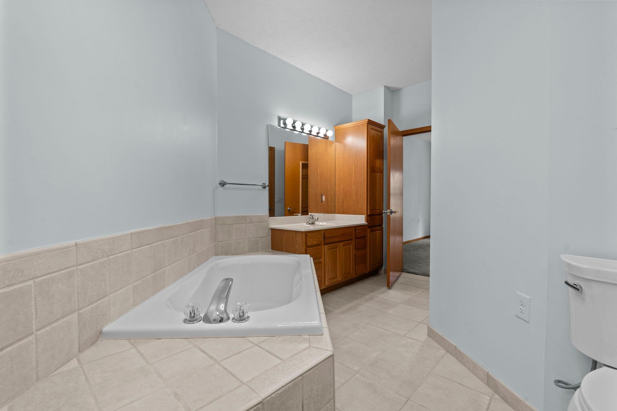 Primary bathroom with beautiful tilework. Large soaking tub and seperate shower.