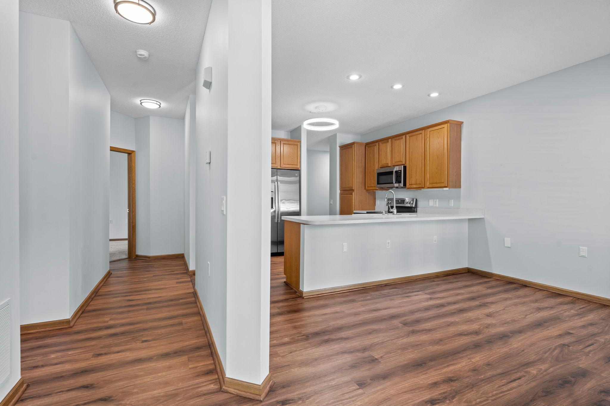 Lovely LVP flooring spans the kitchen and hallway.