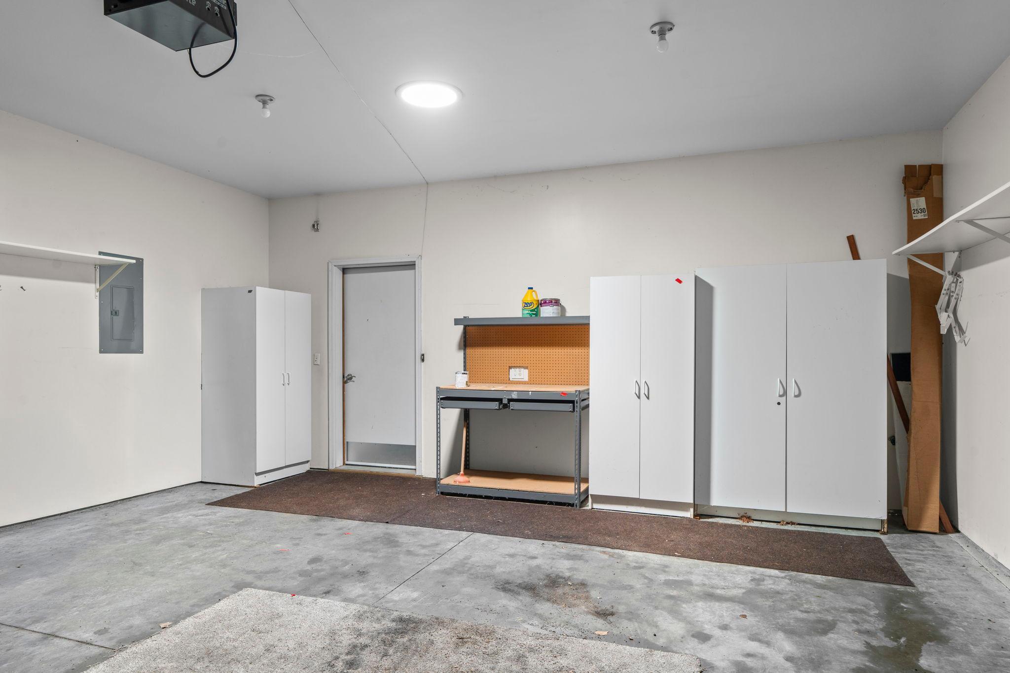 Extra large, 2 car garage space and sotrage cabinets, workbench.