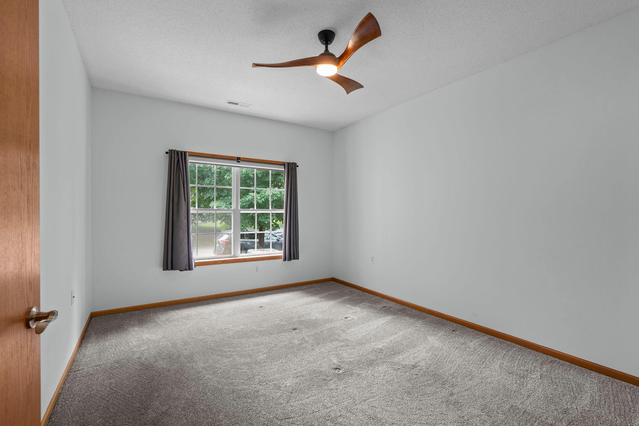 Main level primary bedroom with ensuite bathroom and large closet.