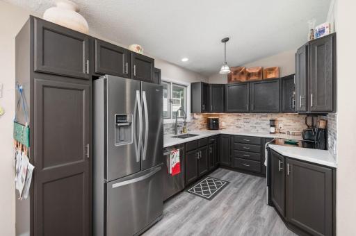 The kitchen remodel included premium cabinetry, stainless appliances, Quartz countertop, commercial grade faucet, tile back splash and flooring!