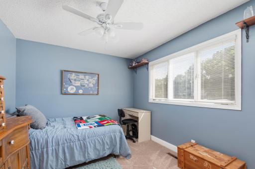 Bedroom 3. All the bedrooms have ceiling fans and white painted trim.