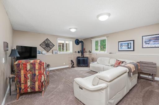 The big family room features a wonderful wood burning stove for the cool seasons and large windows let in natural light.