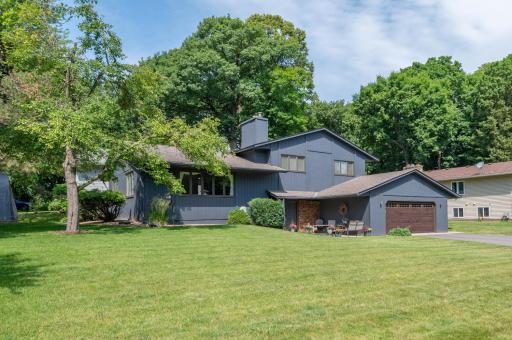 You are greeted by a new driveway, garage door, plush lawn and exterior paint all done in 2025!