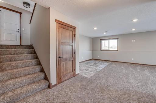 Finished lower level shown is from a previous model home. Lower-level finishing is available as an upgrade for an additional cost. Choose from a variety of colors, cabinets, trims, etc. All photos are from a similar model home.