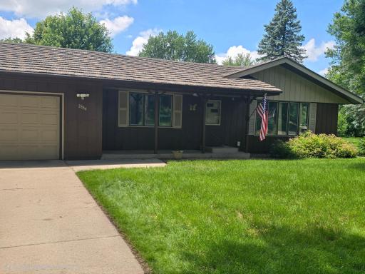 Front entrance to home via concrete driveway and walk