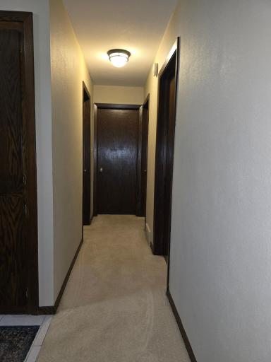 Hallway to bedrooms and bathroom both half bath and full bath with shower