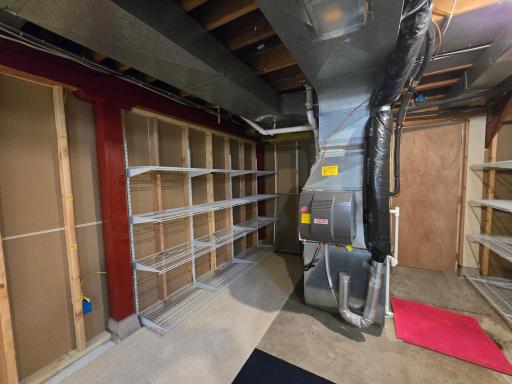 HE natural gas furnace with humidifier and directly behind it a natural gas hot water heater
