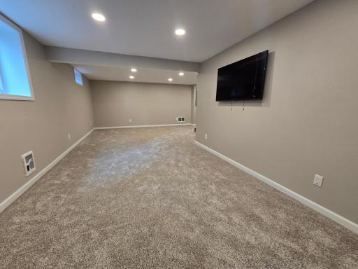 L shaped family room has brand new carpeting