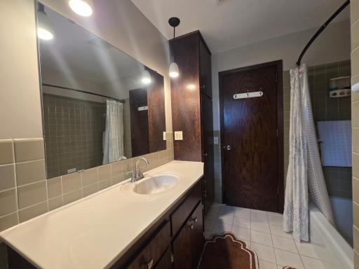 Main full bath has tile floors and tile shower area and porcelain bathtub and shower area with large linen closet. Don't worry, there is proper GFI circuit protection throughout the home ! GFI protects a person from being shocked accidentally.