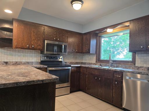 Granite counter tops, ceramic floors and very large window view of the back yard