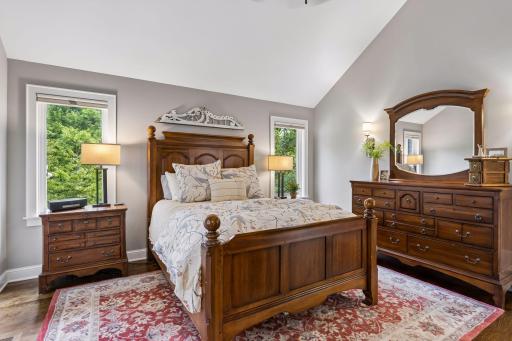 The luxurious primary suite provides a private retreat with vaulted ceilings, an ensuite bathroom and huge walk-in closet.