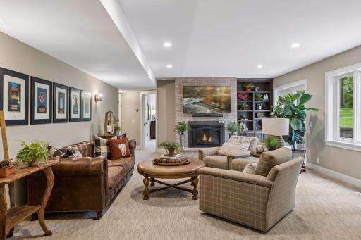 The family room features a beautiful brick fireplace and built-in shelves.