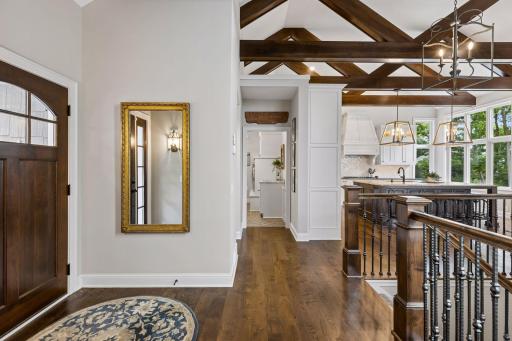 The gracious foyer welcomes guest at the center of the home.