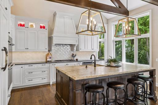 Custom inlaid cabinetry with pull-outs and soft-close features offer abundant, easy access storage.