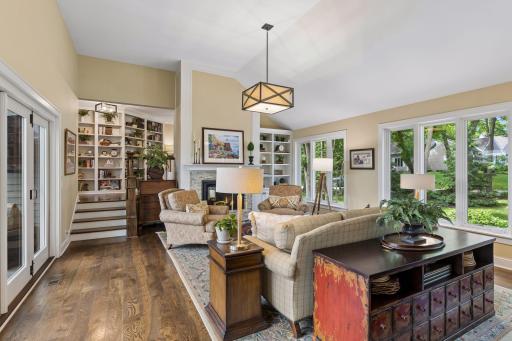 Spacious main-level living room with built-in bookshelves and convenient gas fireplace.