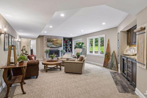 The walkout lower level family room is equally impressive with the same level of craftsmanship, 10 foot ceilings, a built-in bar and gas fireplace.