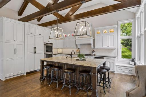 The gourmet kitchen is designed for both entertaining and daily living, featuring a large center island with seating for six.