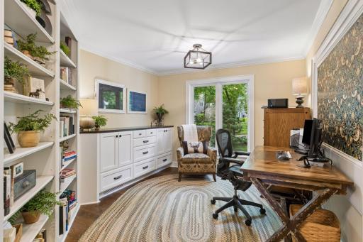 This dedicated office provides custom cabinets and plenty of shelf space to keep organized and tidy.