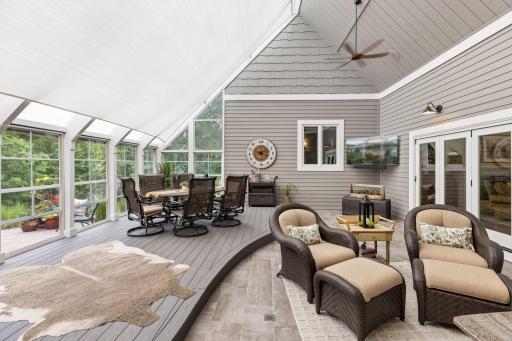 The porch is shielded with a sun sail and windows open for cooling and ventilation.