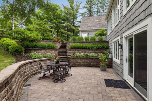 An extensive landscaping project rebuilt hardscape including this private front patio with beautiful perennial gardens.