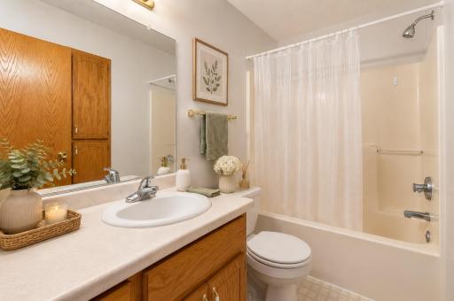 Start and end your day with ease in this full bathroom offering a large vanity with plenty of counter space and storage to help keep essentials organized. Photo has been virtually staged.