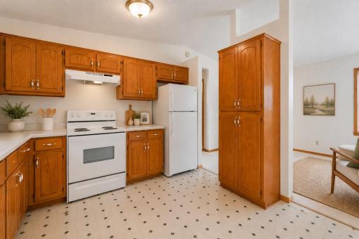 With its walk-through layout and impressive pantry cabinet, this kitchen is designed to keep you connected to the living spaces while providing plenty of room for storage, meal prep, and everyday living. Photo has been virtually staged.