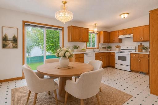 Filled with natural light, the spacious dining area flows seamlessly into the kitchen, where ample storage and workspace make gathering with family and friends easy and enjoyable. Photo has been virtually staged.