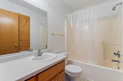 Unstaged view illustrating the bathroom's spacious layout and abundant storage, providing a practical foundation for your personal style.