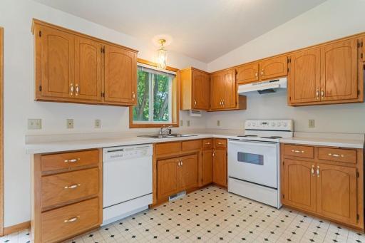 Imagine making this kitchen your own. Beautifully maintained cabinetry in excellent condition, abundant storage, generous counter space, and a window over the sink create a welcoming space ready for your personal style.