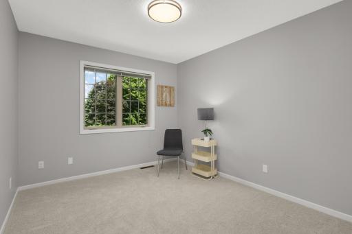 Another generously sized upper-level bedroom overlooking mature landscaping.