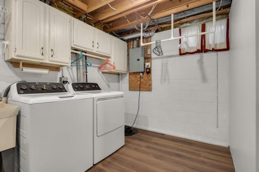 Dedicated laundry room with storage cabinets, hanging space, and room to stay organized year-round. Note the large addition space to the right of the photo during your tour of the property.