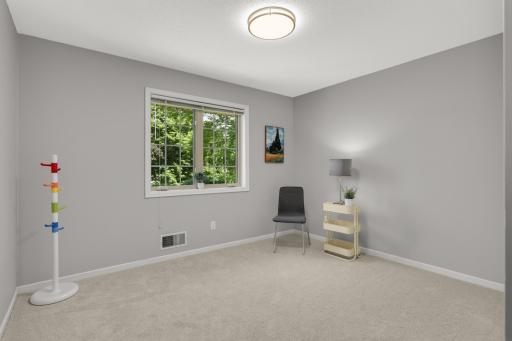 Comfortable secondary bedroom with fresh finishes and abundant natural light.