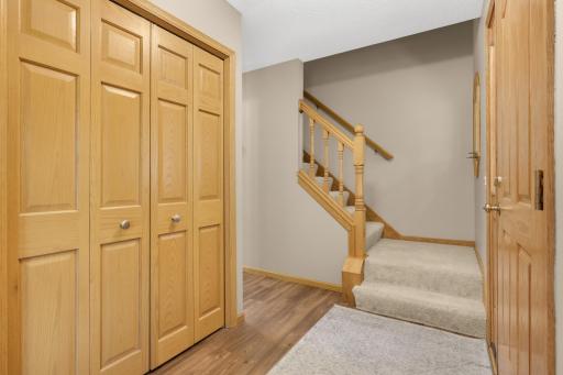 Welcoming front entry features a large coat closet and attractive oak woodwork.