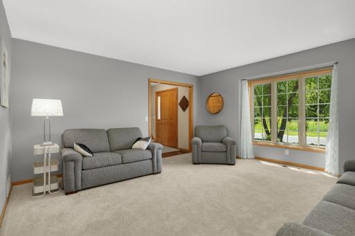 Spacious front living room filled with natural light from large picture windows.