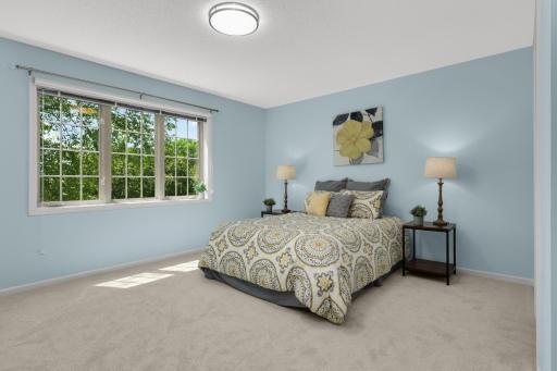 Expansive primary suite offers room for larger furniture and a peaceful treetop view.