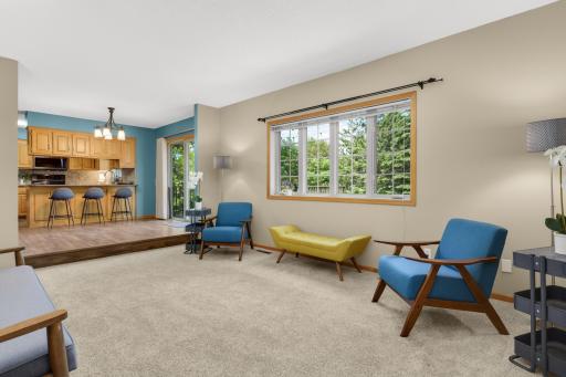 Spacious main-level family room filled with natural light and large windows overlooking the private backyard.