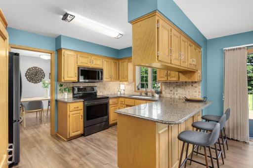 Granite countertops, abundant cabinetry, and a center island make this kitchen both functional and inviting.