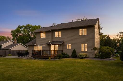 Large, private backyard with mature landscaping and room to relax, play, or gather with friends.