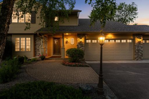 Inviting covered front porch and paver walkway create a warm welcome home.