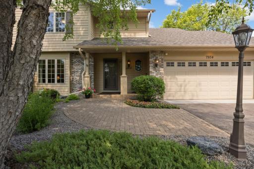 Charming paver walkway leads guests to the covered front entry. Thoughtfully designed front elevation offers timeless style and a welcoming presence.