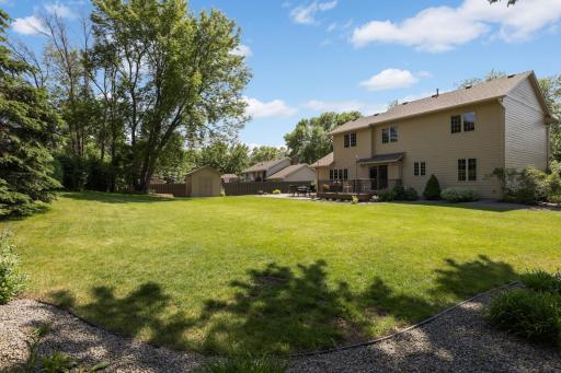 Large, private backyard with mature landscaping and room to relax, play, or gather with friends.