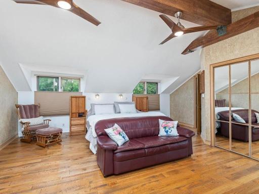 Private Primary Suite features vaulted ceiling, Full Bath, walk-in closet, and Screened Porch overlooking the lake for amazing sunrises!