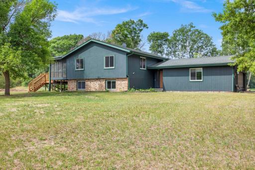 Freshly painted siding, attached garage, screen porch and deck.