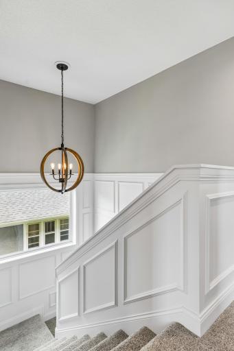 Classic wainscoting along the stairway adds architectural detail and timeless character.