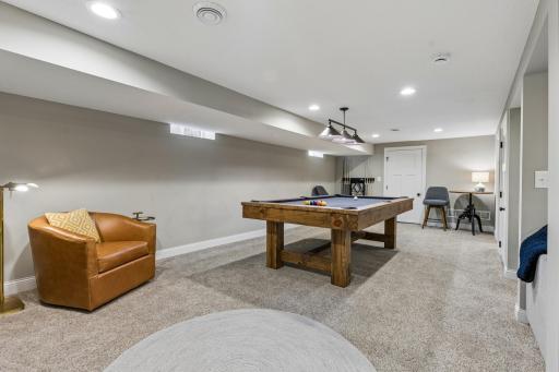 Comfortable lower level family room designed for relaxing, entertaining, or media use.