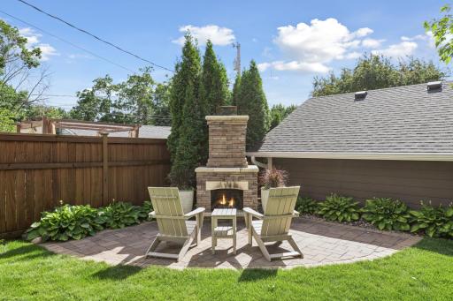 Enjoy evenings by the custom outdoor fireplace, perfect for gatherings and relaxation.
