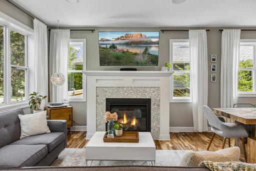 Beautiful tiled fireplace adds warmth, character, and style to the main living space.